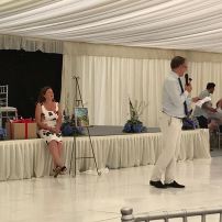 Mr Charles Hanson in action during prize auctions with Mrs Julia Needham in the background.